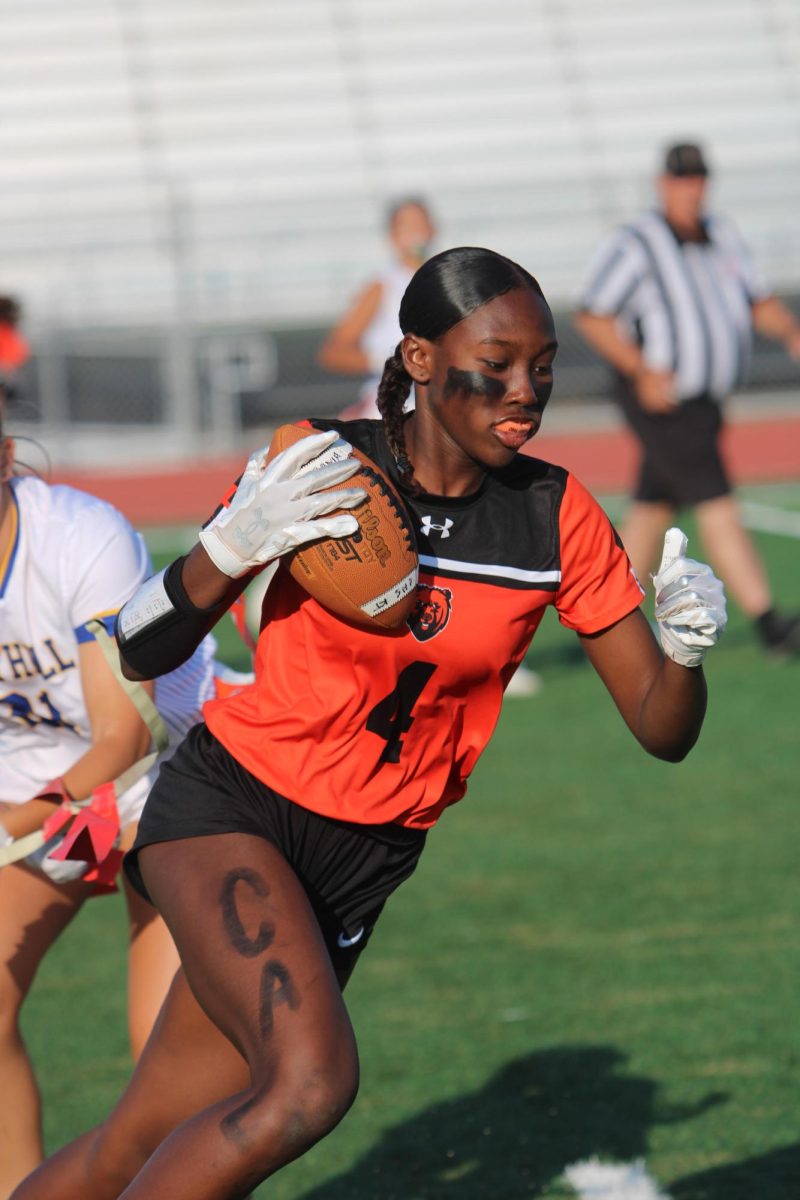 Junior Olivia Young evades a defensive player with the ball for Cal’s flag football team.