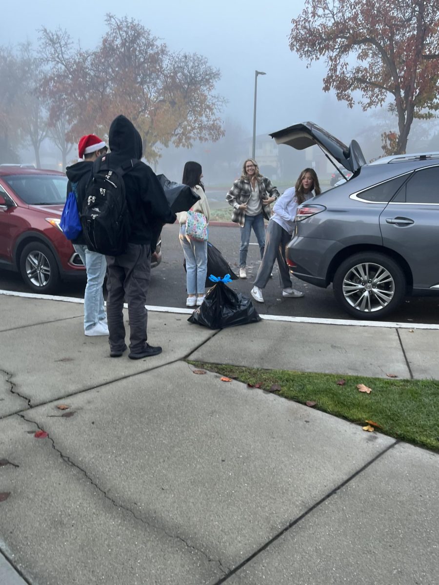 Leadership students load cars with bags of toys for the Michelle Obama toy drive.