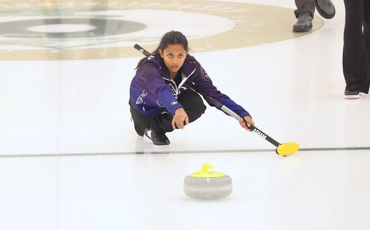 Freshman+Krisha+Umanshankar+throws+the+rock+in+hopes+of+scoring+at+the+U18+Curling+National+Chapionships.+Umanshankar+was+part+a+San+Francisco+team+that+qualified.