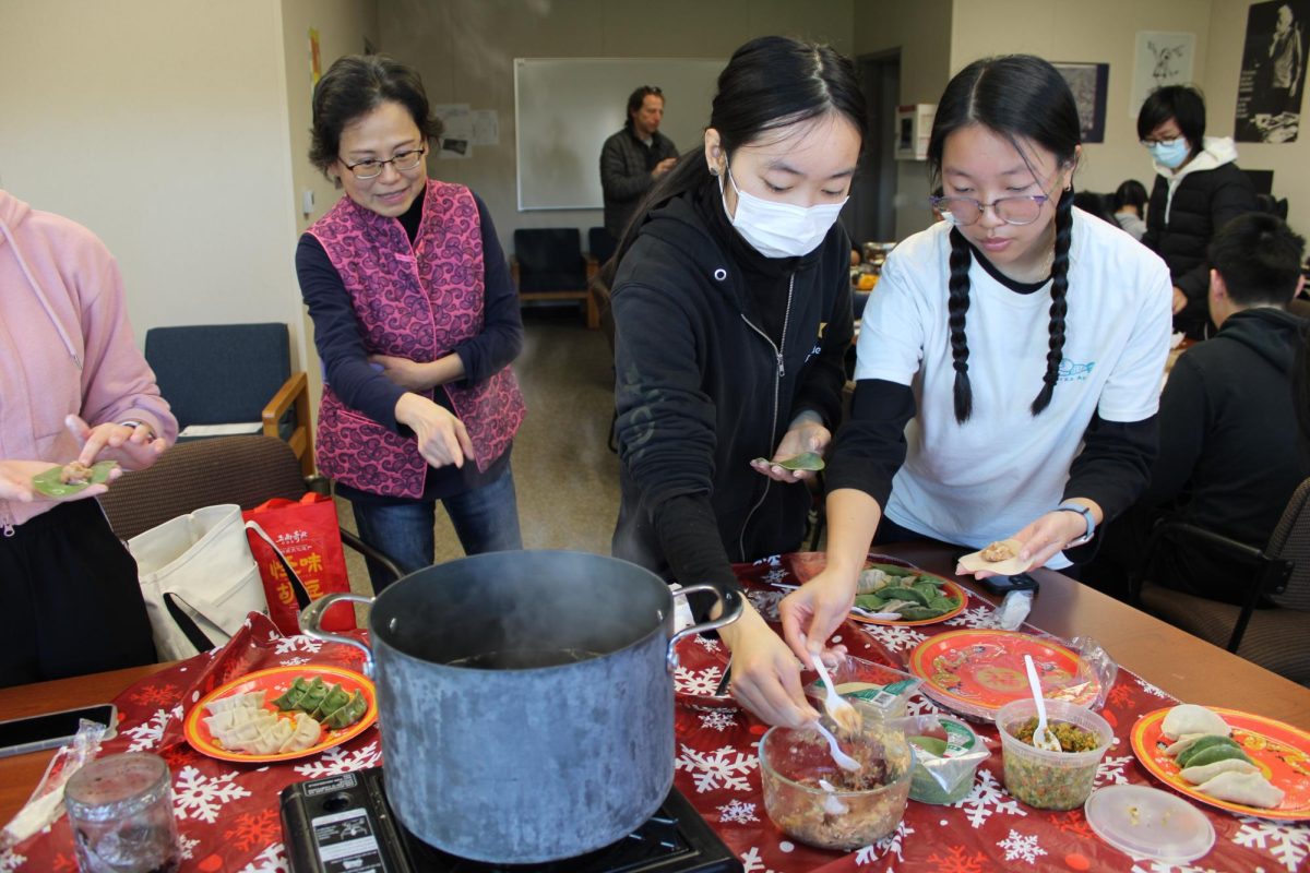 From left to right, Chinese teacher Winnie Wang watches as senior Elva Chen and junior Cassidy Chiang stuff dumplings with pork and cabbage filling as a class activity for the Lunar New Year, which began last Saturday. If the Korean class starts next year, students will have the opportunity to experience Korean cultural activities similar to this at school. 