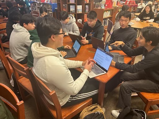 Jaemin Kim, Katelyn Pak, Jerry Xu, Evan Lee, Aswath Subramanian, Nam-An Pham, Ayaan Bazaz, Aditya Patra, Alexander Pak, Kanishk Krishna, and William Li, members of the XR EDU club, work on the Samsung Solve for Tomorrow competition in the library. The club is a state finalist in the competition for the second year in a row.