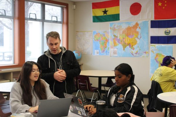 Ethnic Studies teacher Benjamin Andersen talks with Addison Hooi during independent classwork time.