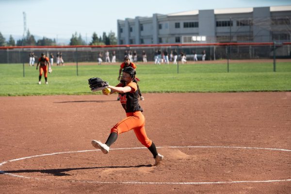 Varsity pitcher Kaitlyn Le winds up to throw a pitch against Dougherty Valley on March 19. The Grizzlies won the game 6-1. Le, a senior, is committed to play softball for CSU Monterey Bay next season. 