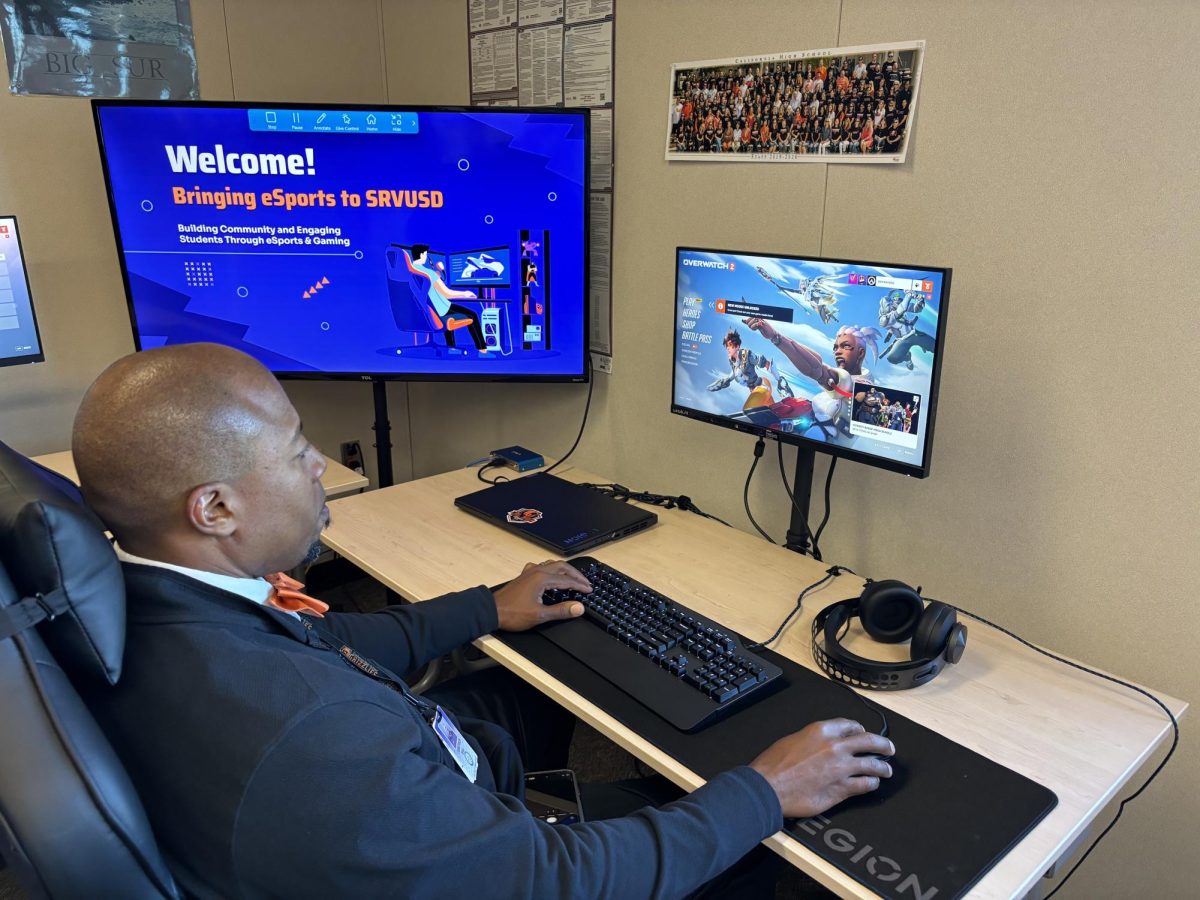 Cal High Principal Demitrus Ball plays “Overwatch” during the Esports Club open house on March 19. The open house was designed to educate school and district administrators about the potential growth for esports.