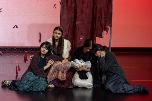 From left to right, seniors Manya Singh, Paloma Jackson Kimball, Elizabeth Spencer, and junior Annalise Wedewer act out an emotional scene in “Women of Troy”, where they say their last goodbyes to the queen’s grandson.