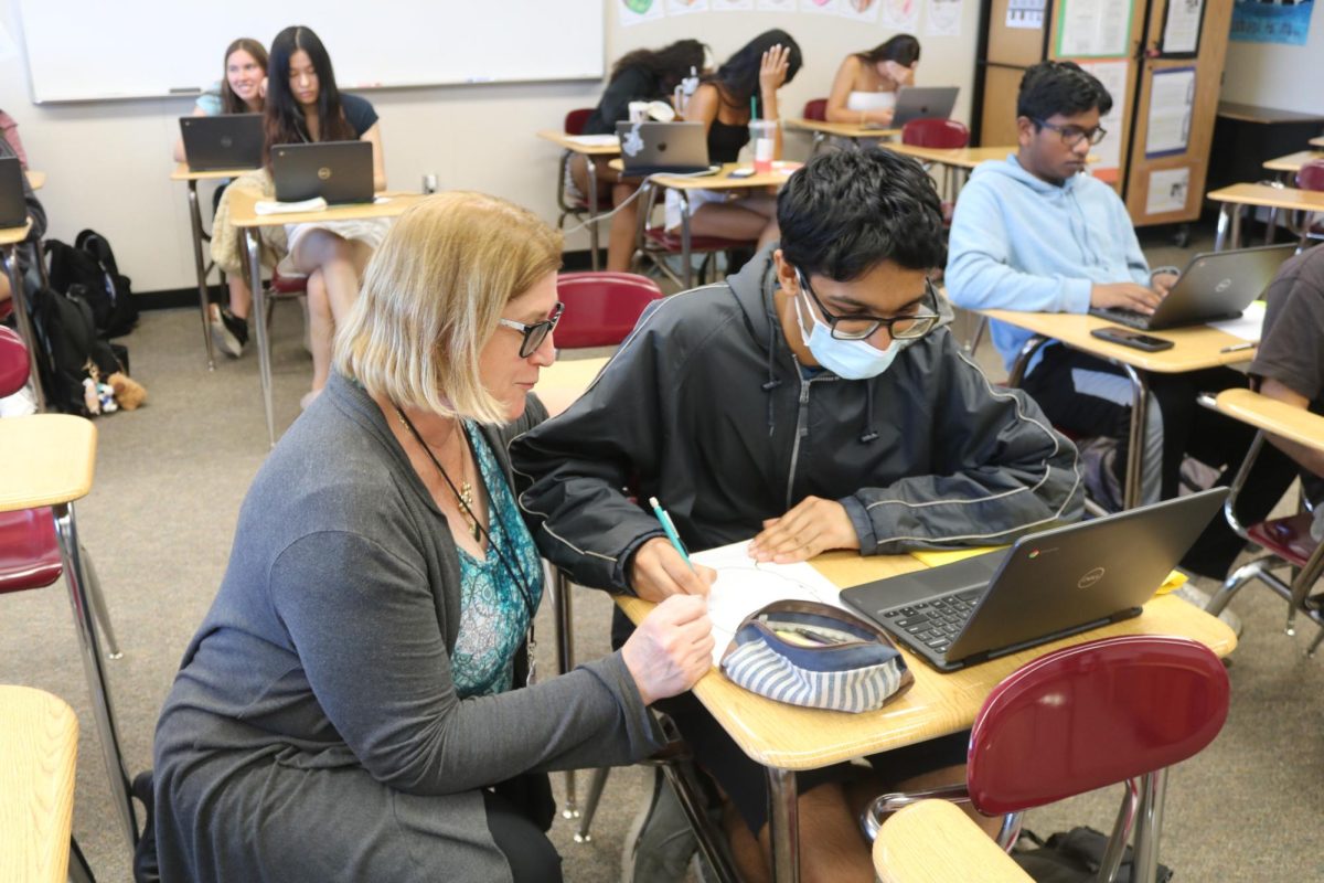 English teacher Donna Montague works with senior Vishnu Bharadwaj on his writing during class. Montague, who started teaching at Cal High in 1986, is retiring after a 38-year career where she has taught thousands of students.