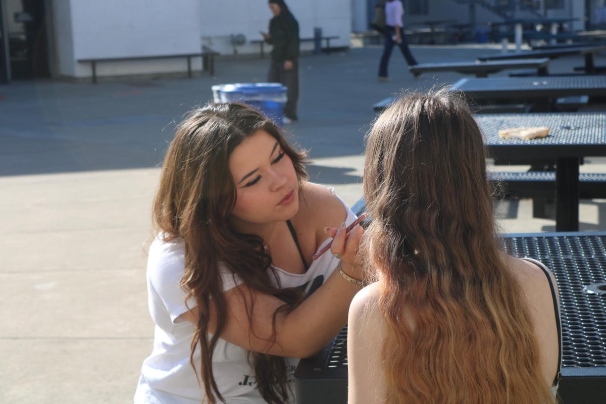 Ashleigh Maple being precise and careful while doing sophomore Em Somsel’s makeup at Cal. Maple has continued cultivating the makeup business she started in her junior year.