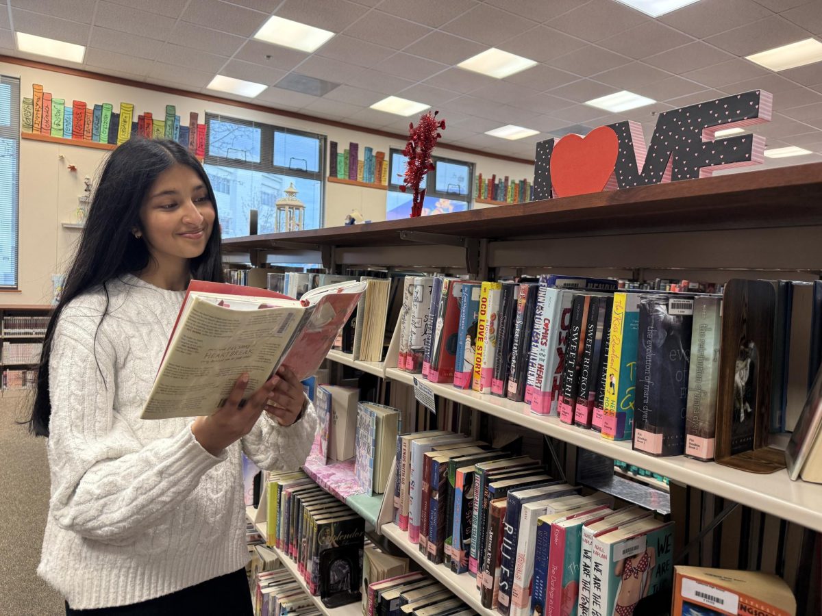 Freshman Riddhi Kanthed looks through a romance novel she’ll enjoy reading this month. Cal’s library has a whole section of romance novels that are perfect for Valentine’s Day.