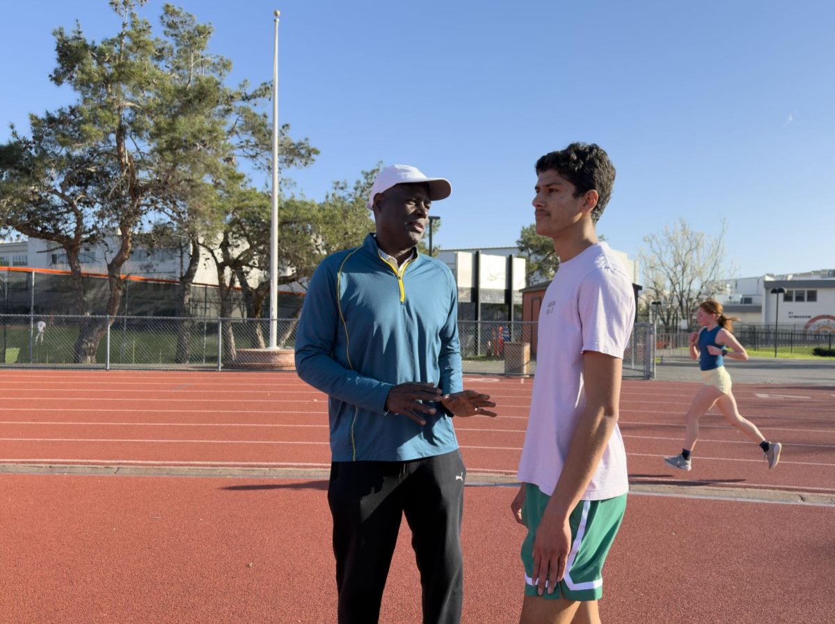 Cal High high jump coach James Frazier (left) explains to junior Ishaan Varma how to improve his form during a recent practice. Frazier has been coaching Cal’s high jumpers for the past 18 seasons after competing at University of Arizona, where he held the high jump record for 34 years. Frazier has been in the University of Arizona’s Hall of Fame since 2014.