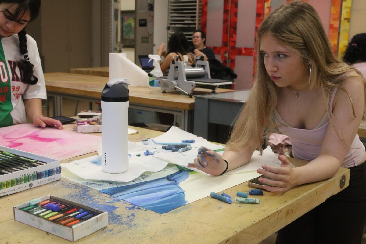 Sophmore Callie McDonald  paints with oil pastels in her Art 3 class. The San Ramon Valley Unified School District’s proposed cuts to at least 16 full time teaching positions predominantly target elective classes such as art, theater, and world languages. Cal High could face the elimination of several of these elective classes beginning next school year.