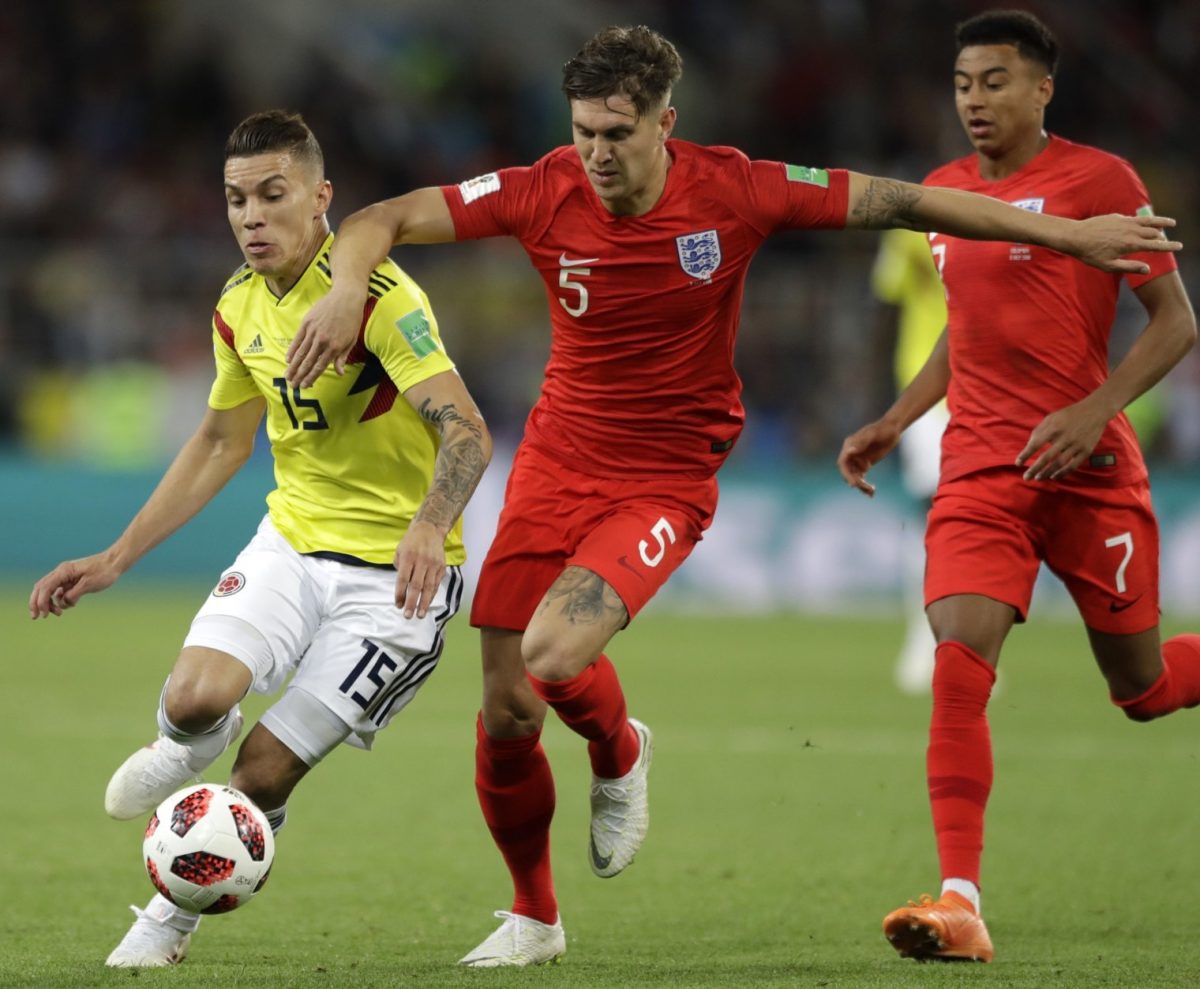 England’s center back John Stone fights for the ball against Colombia’s Mateus Uribe at the 2018 World Cup. England won the match 4-3.