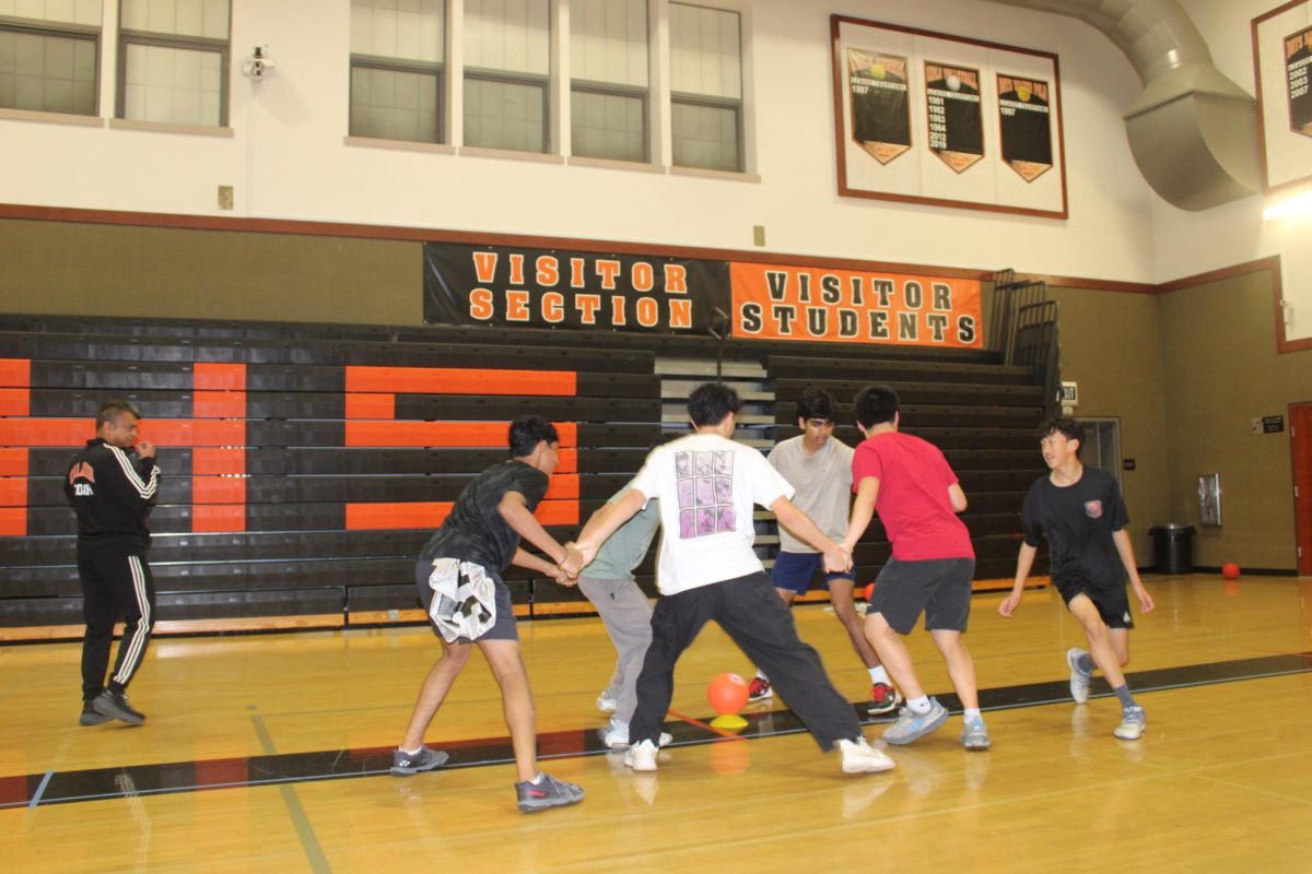 Badminton players defend a dodgeball from an attacker during practice. This is one of team’s many unusual exercises used to keep players in shape for the demanding sport.   