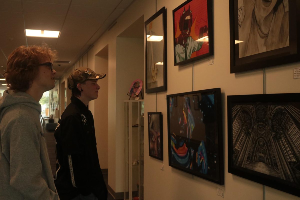 Students from Monte Vista High School admire paintings in the gallery at San Ramon City Hall on April 21. The art gallery displayed pieces from all district school students. 