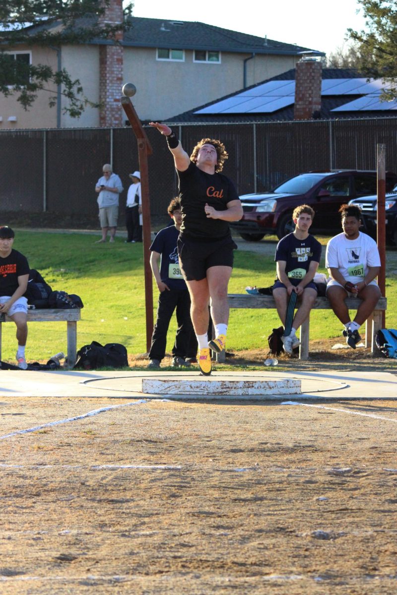 Senior captain Magnus Carlson launches the shot put during the Mirawest dual track meet. 